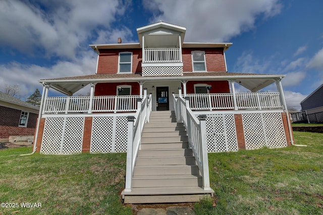 view of front facade featuring a porch, a front lawn, and stairs