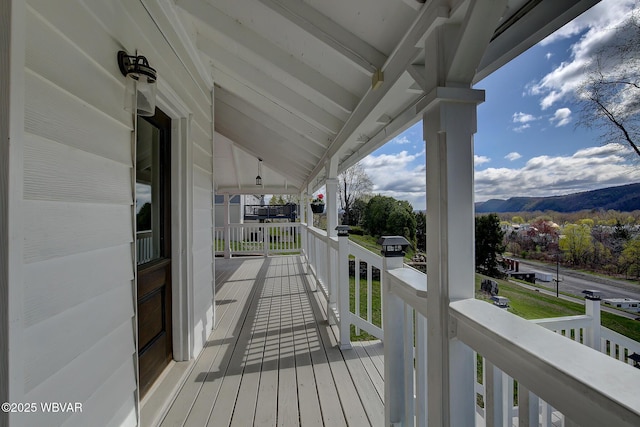 deck featuring a porch and a mountain view