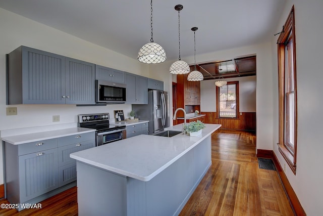 kitchen featuring gray cabinets, light countertops, visible vents, stainless steel appliances, and a sink