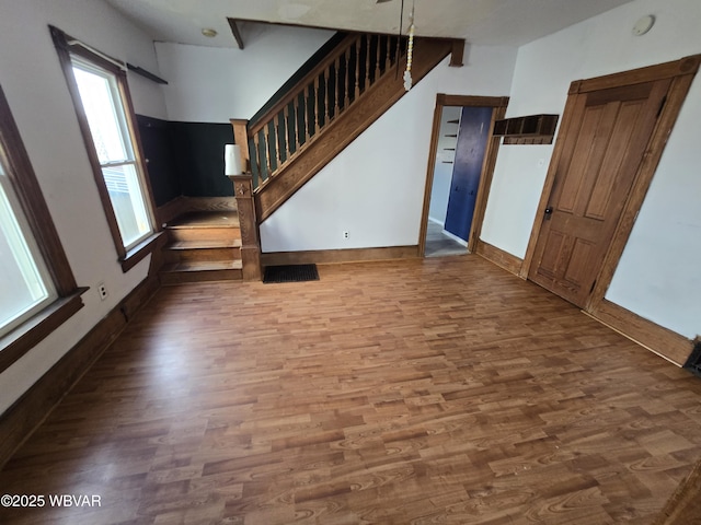 1013 Allegheny St, Jersey Shore, PA 17740 - unfurnished living room with wood finished floors, stairs, and baseboards