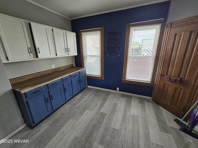 1013 Allegheny St, Jersey Shore, PA 17740 - kitchen featuring blue cabinetry, light wood-style floors, white cabinets, ornamental molding, and baseboards