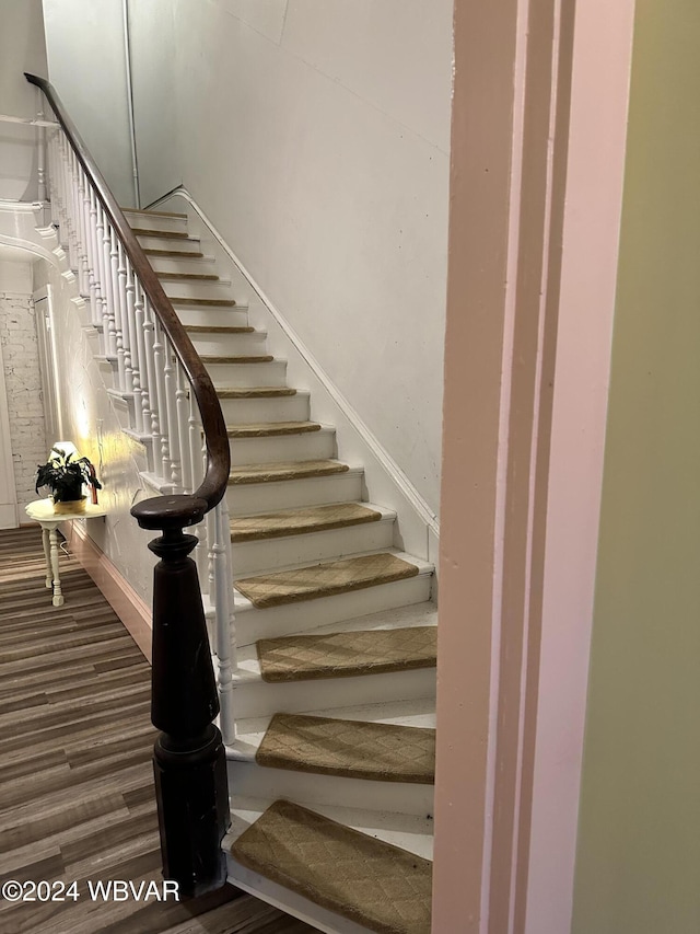 staircase with hardwood / wood-style flooring