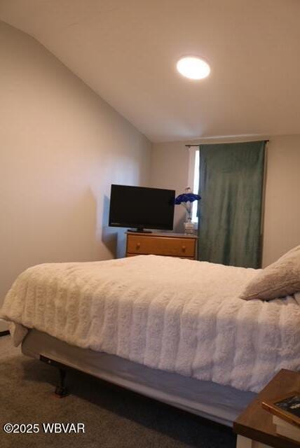 carpeted bedroom with vaulted ceiling