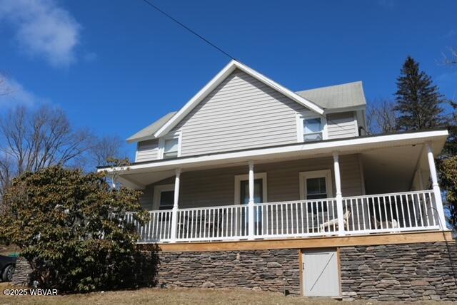 view of side of property featuring a porch