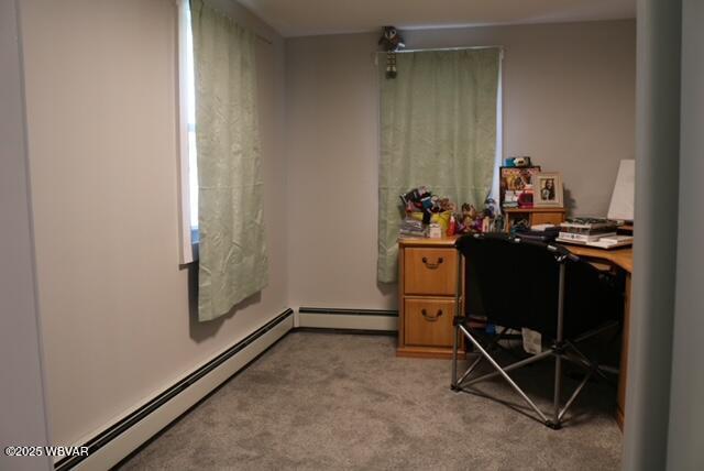 bedroom with light carpet and a baseboard radiator