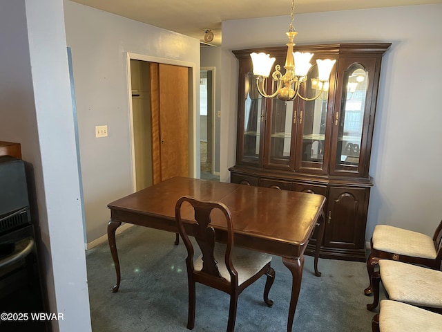 dining space featuring a chandelier and carpet flooring