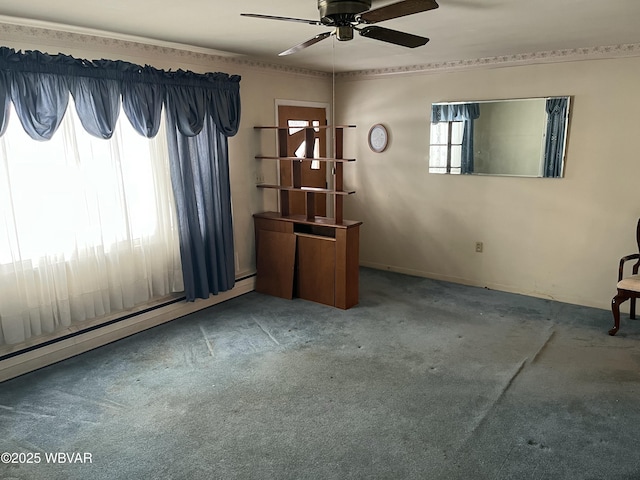 empty room with carpet, ceiling fan, and a baseboard heating unit