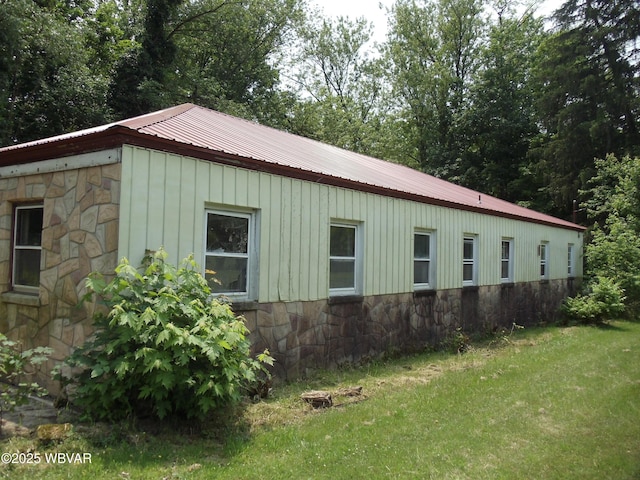 5801 N Rt 220th Hwy, Linden, PA 17744 - view of home's exterior featuring stone siding, board and batten siding, a lawn, and metal roof