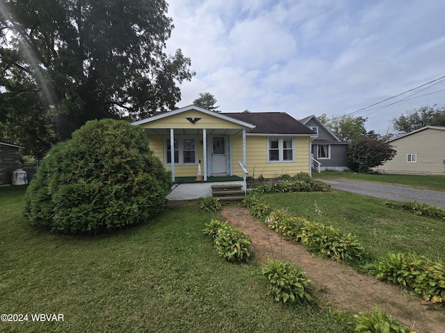 bungalow featuring a porch and a front yard