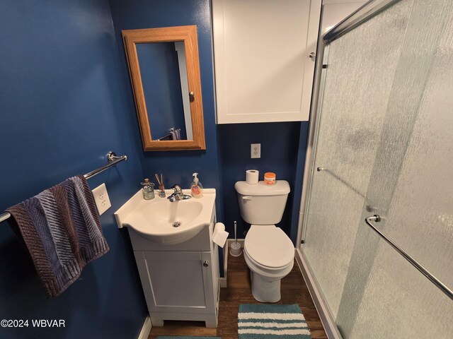 bathroom featuring vanity, hardwood / wood-style flooring, and toilet