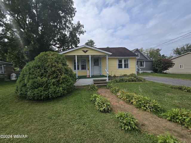 bungalow-style house featuring a front lawn and covered porch