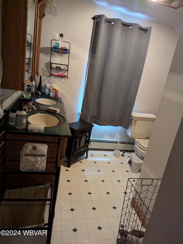 bathroom with vanity, a baseboard radiator, and toilet