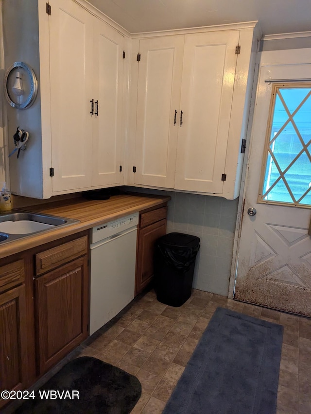 kitchen with white cabinets, dishwasher, and tasteful backsplash