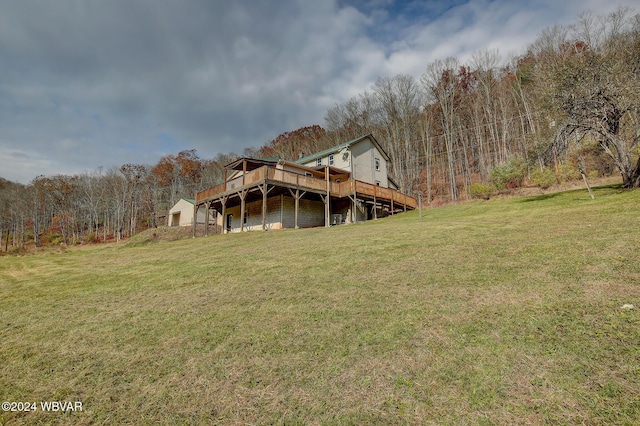 rear view of house featuring a yard and a deck