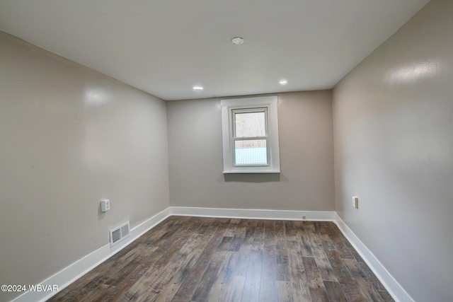 empty room with dark hardwood / wood-style floors