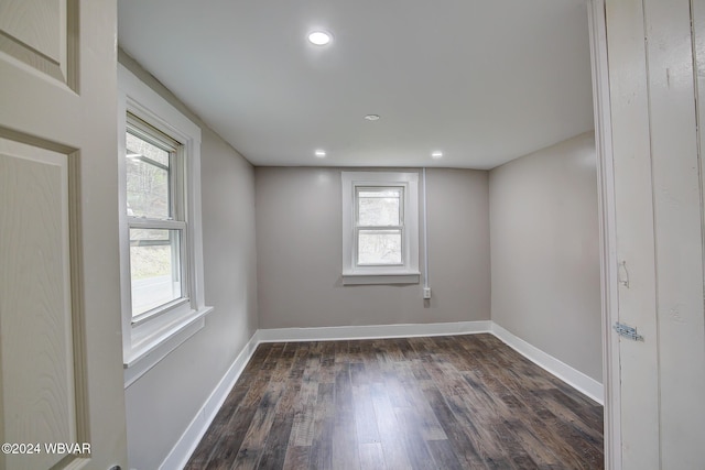 unfurnished room featuring dark wood-type flooring