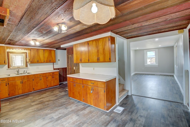 kitchen featuring light hardwood / wood-style flooring, wood ceiling, and sink