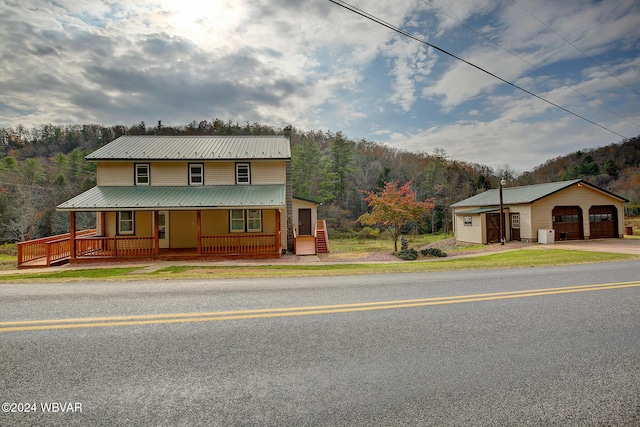 view of front of house with a porch, an outdoor structure, and a garage