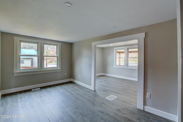 unfurnished room with wood-type flooring