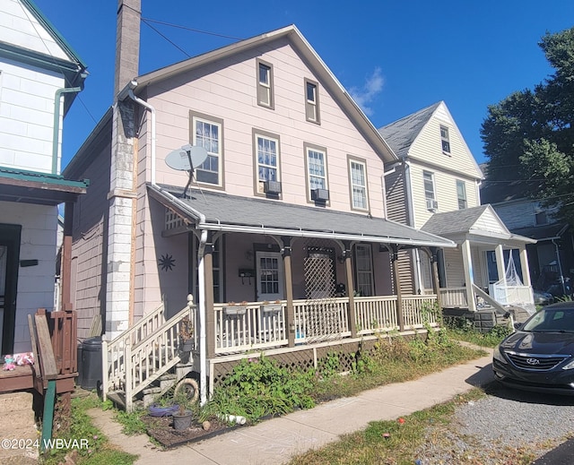 view of front of home with a porch and cooling unit