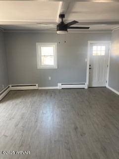 interior space with a baseboard heating unit, baseboards, and a ceiling fan