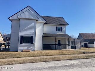 view of front of home with covered porch and metal roof