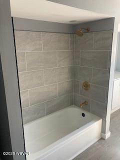 full bathroom with shower / bath combination and wood finished floors