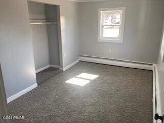 unfurnished bedroom featuring a closet, baseboards, and carpet