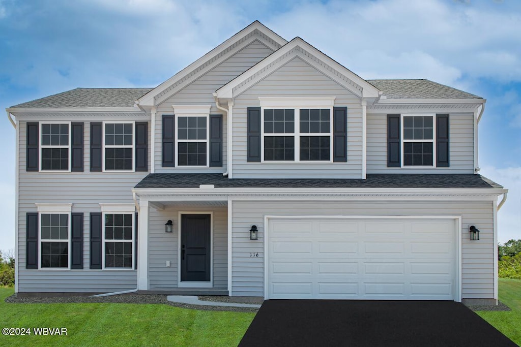 view of front facade with a front lawn and a garage