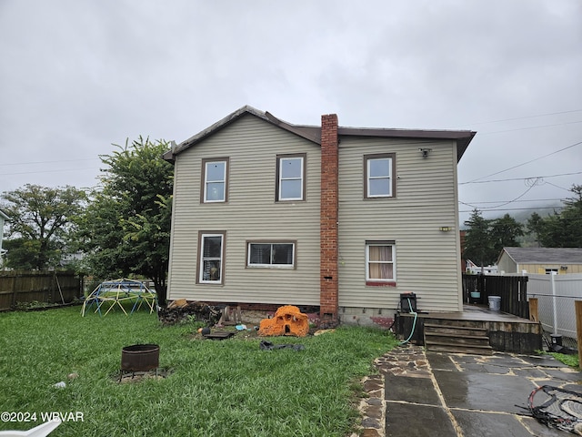 back of house featuring a yard and a patio area