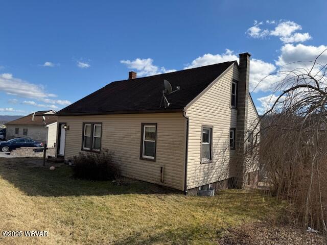 view of side of home featuring a yard