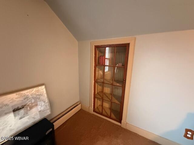 interior space featuring carpet flooring and a baseboard heating unit