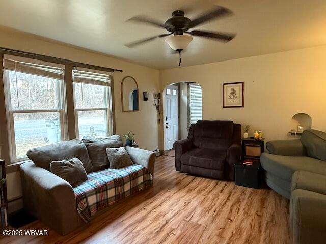 living room with ceiling fan and light wood-type flooring