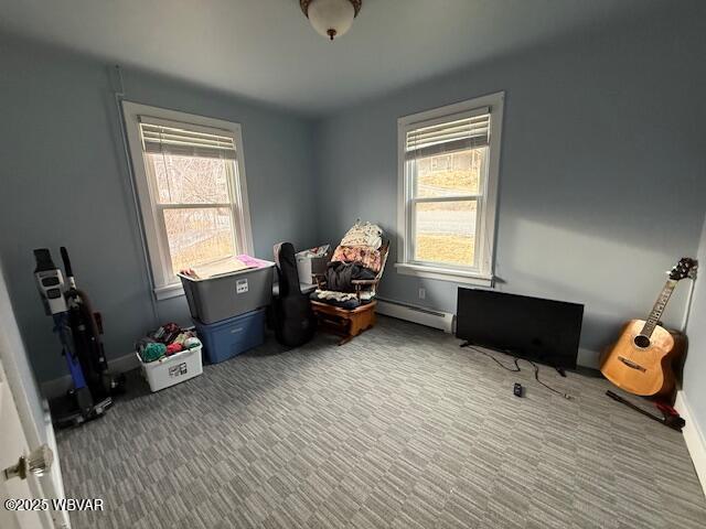 office area featuring a baseboard radiator, plenty of natural light, and carpet flooring