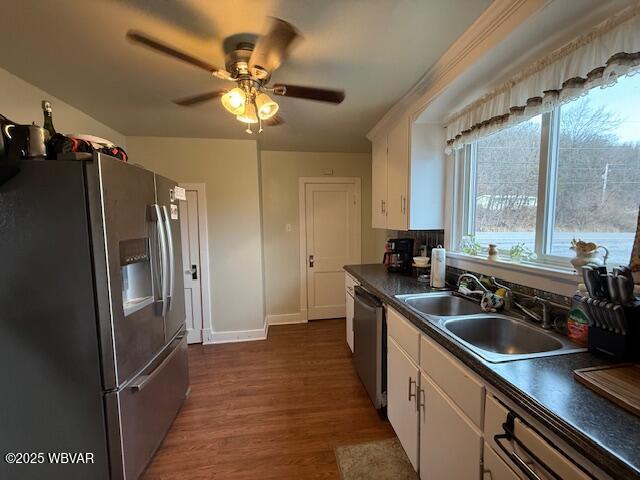 kitchen with dark wood-type flooring, sink, ceiling fan, stainless steel appliances, and white cabinets