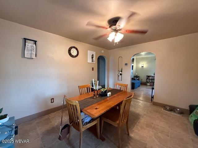 tiled dining space featuring ceiling fan