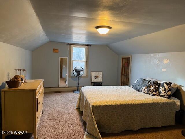 carpeted bedroom with vaulted ceiling