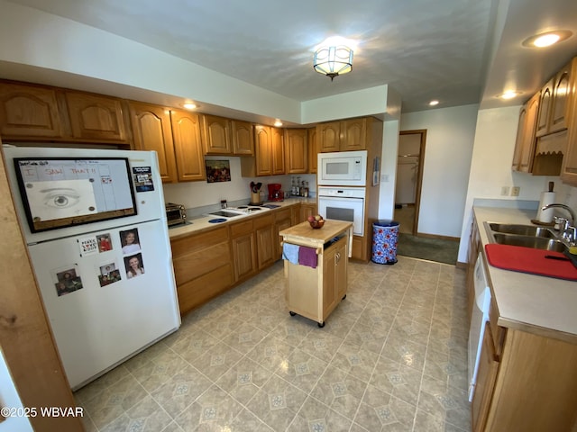 32 Chestnut Ct, Jersey Shore, PA 17740 - kitchen featuring brown cabinets, a sink, white appliances, light countertops, and a center island