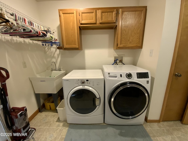 32 Chestnut Ct, Jersey Shore, PA 17740 - washroom featuring light tile patterned flooring, baseboards, washer and clothes dryer, a sink, and cabinet space