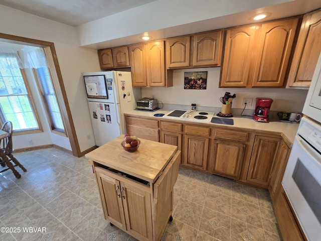 32 Chestnut Ct, Jersey Shore, PA 17740 - kitchen with white appliances, brown cabinetry, baseboards, a toaster, and a kitchen island