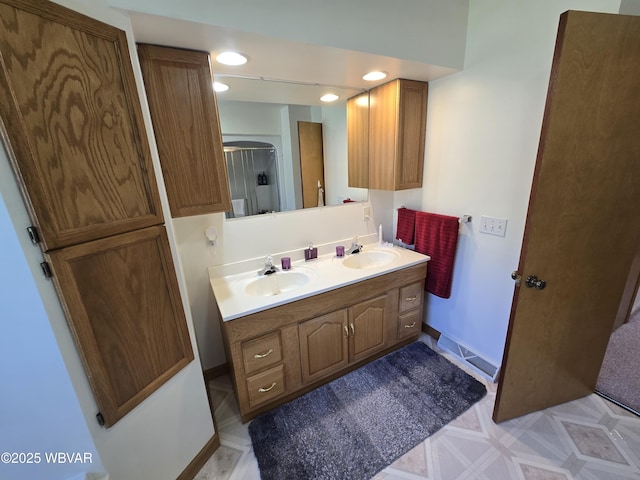 32 Chestnut Ct, Jersey Shore, PA 17740 - full bathroom featuring an enclosed shower, double vanity, baseboards, and a sink