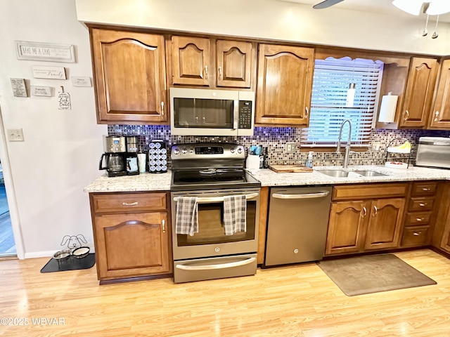 15 Hillview Ave, Williamsport, PA 17701 - kitchen with appliances with stainless steel finishes, a sink, light wood finished floors, decorative backsplash, and ceiling fan