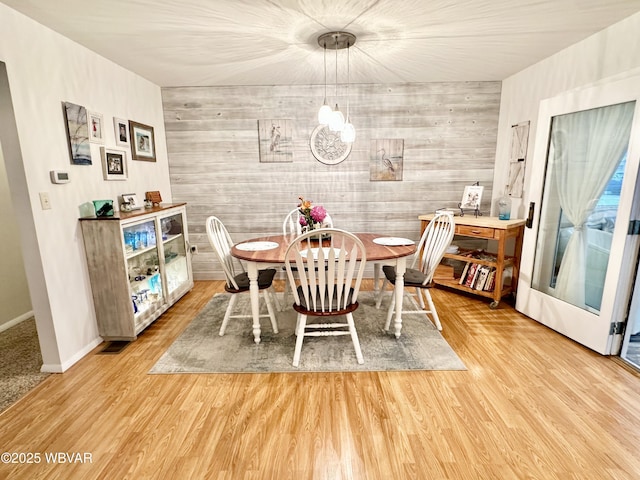 15 Hillview Ave, Williamsport, PA 17701 - dining room featuring a chandelier, light wood-style flooring, wooden walls, and baseboards