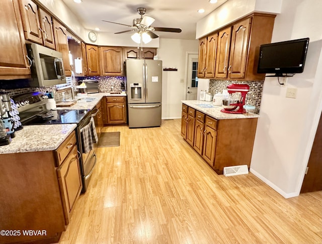 15 Hillview Ave, Williamsport, PA 17701 - kitchen with appliances with stainless steel finishes, a sink, light wood-style flooring, decorative backsplash, and recessed lighting