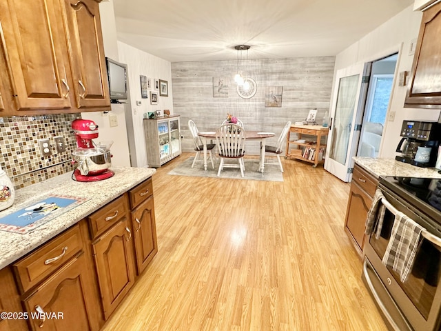 15 Hillview Ave, Williamsport, PA 17701 - kitchen with electric range, light wood-type flooring, and brown cabinetry