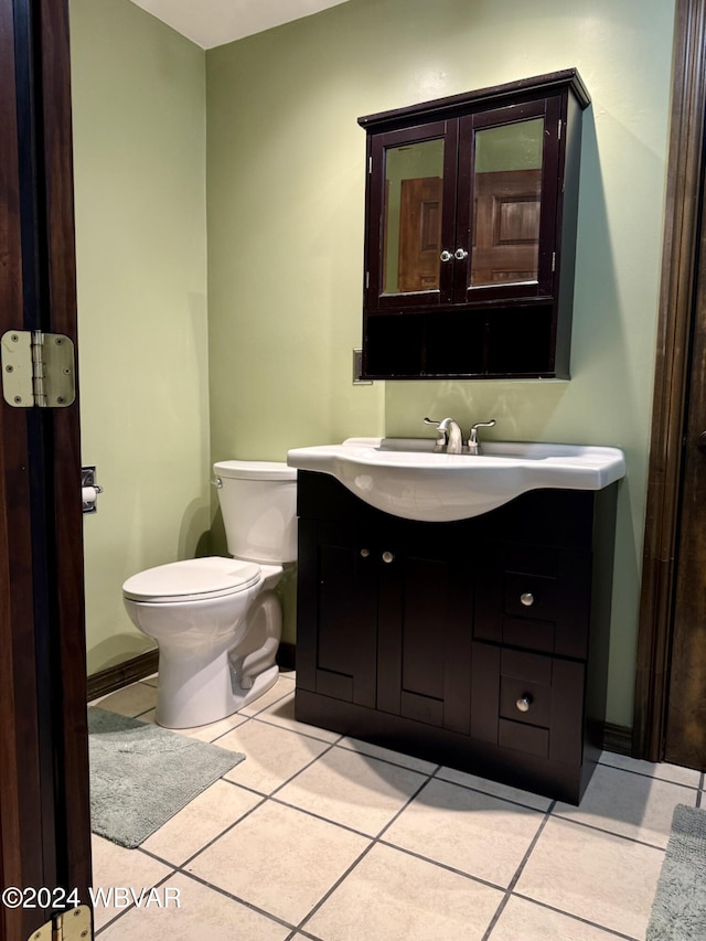 bathroom featuring tile patterned floors, vanity, and toilet