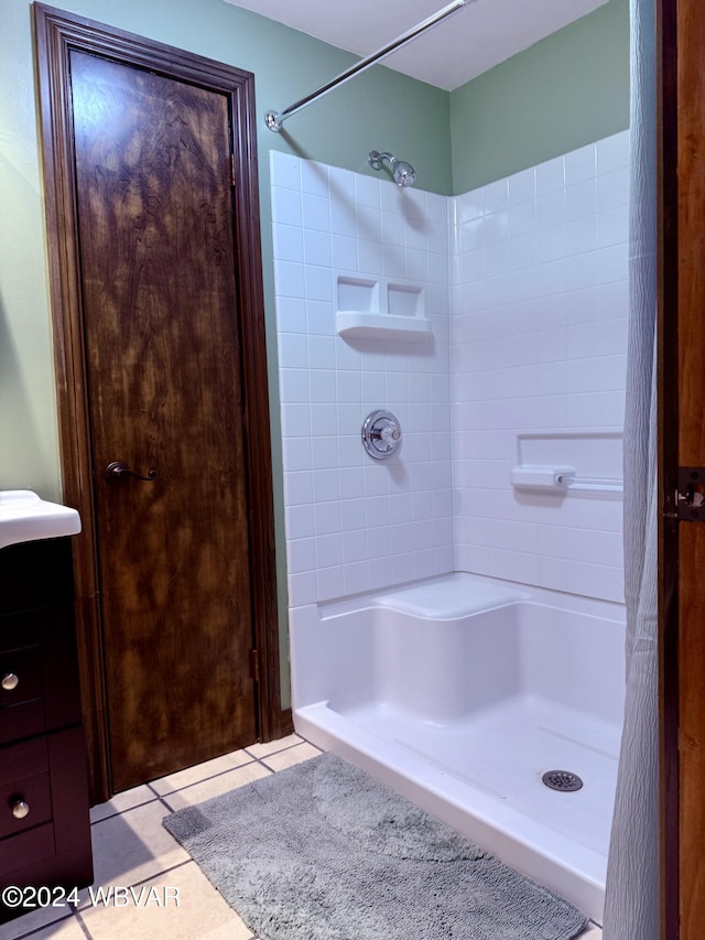 bathroom featuring a tile shower and tile patterned floors