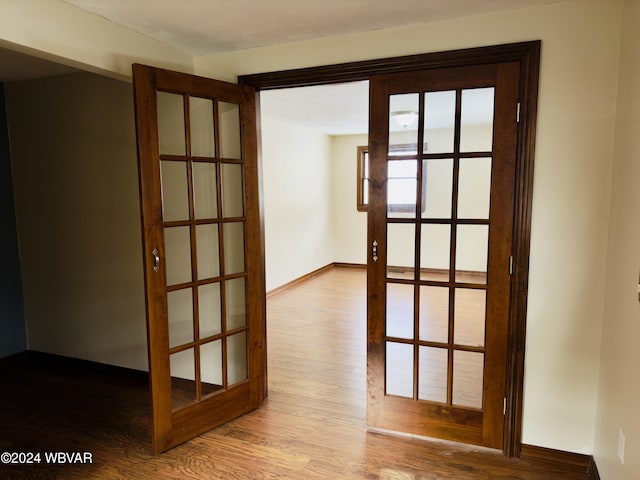 spare room with french doors and hardwood / wood-style flooring