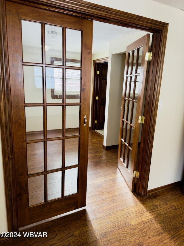 hallway featuring hardwood / wood-style floors and french doors