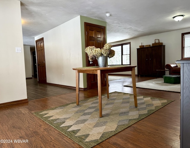 dining area featuring a textured ceiling, plenty of natural light, and dark wood-type flooring